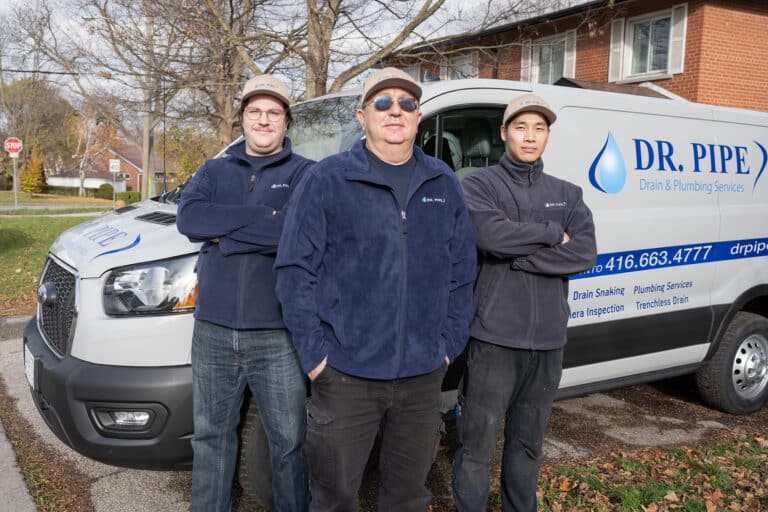 Dr. Pipe technicians in front of a service van for garden suites plumbing in Toronto