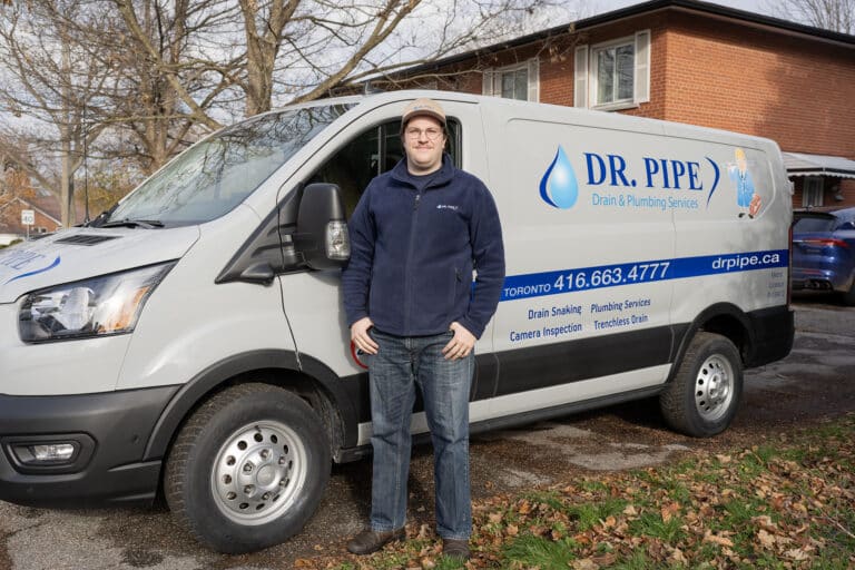 Dr. Pipe technician in front of a service van for cast iron pipe descaling in Toronto