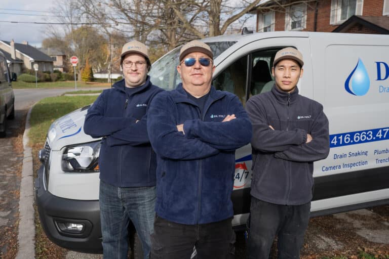 Dr. Pipe technicians in front of a service van for running a new water main in Toronto
