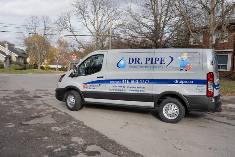 Dr. Pipe technician in front of a service van for toilet installation in Toronto